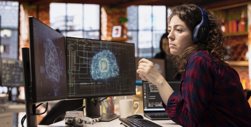 AI industry startup technician coding and listening podcasts in office